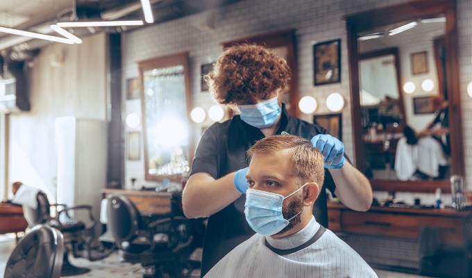 Barber and his client wearing face masks during COVID-19